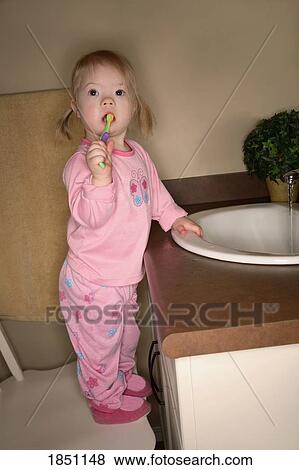 Stock Photo - Young girl brushing her teeth. Fotosearch