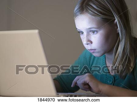 Young girl on a lap top View Large Photo Image Stock Image - Young girl on a lap top. Fotosearch
