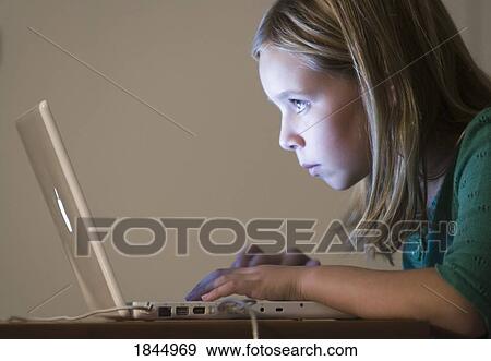 Stock Photo - Young girl using computer. Fotosearch