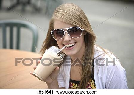 Young woman; Young woman has a drink View Large Photo Image Stock Image - Young woman; Young woman has a drink. Fotosearch