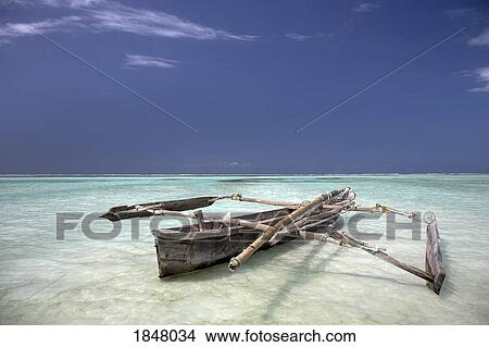 Picture - Zanzibar, Africa; Dhow in the water . Fotosearch