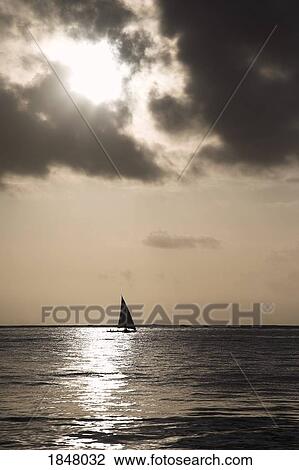 Stock Image - Zanzibar, Tanzania; Sailing into the sunset . Fotosearch