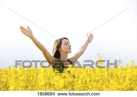 A young woman in a canola field View Large Photo Image Picture - A young woman in a canola field. Fotosearch