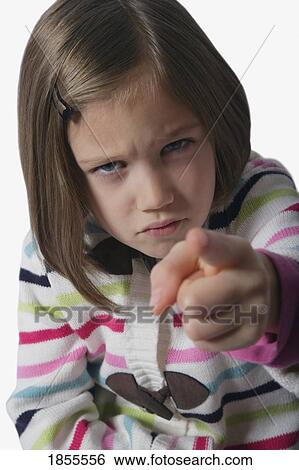 Stock Photograph - Angry girl, pointing her finger. Fotosearch