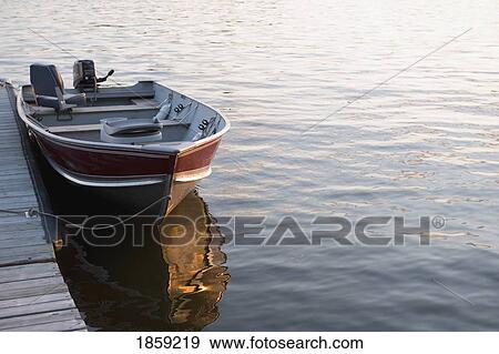 Stock Photo - Boat at dock, Lake of the Woods, Ontario, Canada. Fotosearch