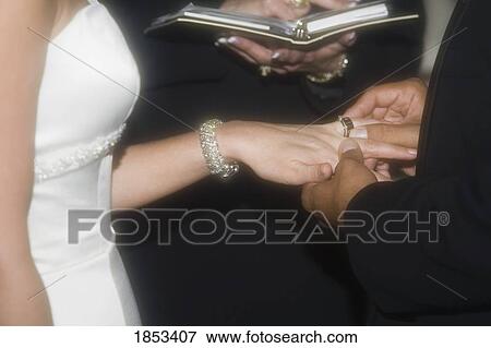 Bride and groom exchanging rings View Large Photo Image Stock Photo - Bride and groom exchanging rings. Fotosearch