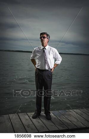 Businessman standing on dock View Large Photo Image Stock Photo - Businessman standing on dock. Fotosearch
