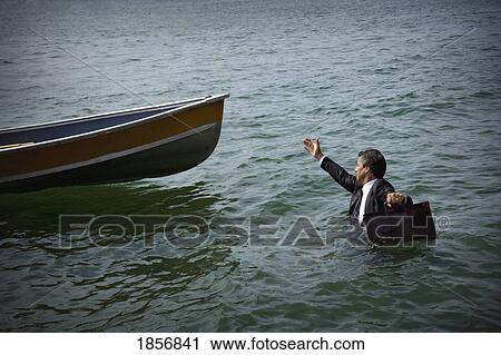 Businessman wading through water towards boat View Large Photo Image Stock Image - Businessman wading through water towards boat. Fotosearch