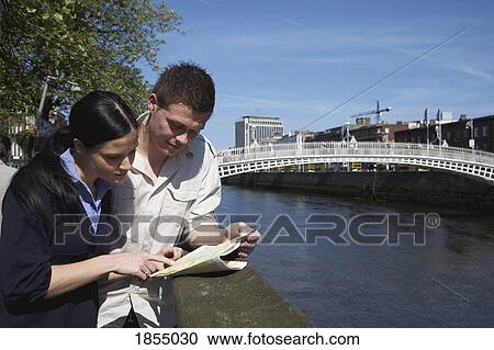 Stock Image - Couple reading a map. Fotosearch