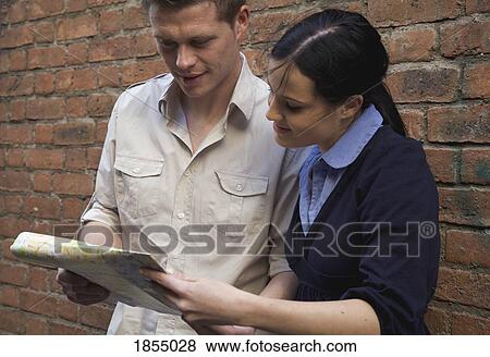 Couple reading a map View Large Photo Image Stock Photo - Couple reading a map. Fotosearch