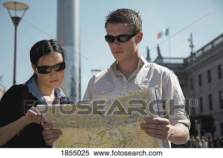 Stock Photography - Couple reading a map. Fotosearch