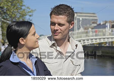 Stock Photo - Couple smiling at eachother. Fotosearch