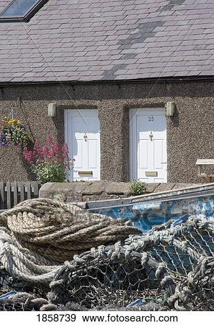 Stock Photo - Fishing nets outside of a cottage, Boulmer, Northumberland, England. Fotosearch