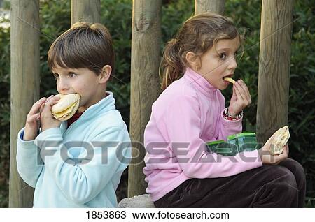 Girl and boy eating sandwiches View Large Photo Image Stock Image - Girl and boy eating sandwiches. Fotosearch