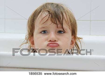 Stock Photography - Girl in the bathtub, pouting. Fotosearch