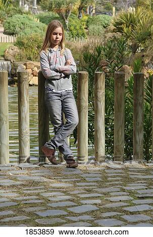 Girl leaning on posts View Large Photo Image Stock Photo - Girl leaning on posts. Fotosearch