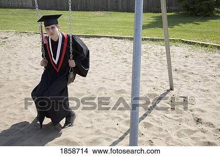 Graduate sitting on a swing View Large Photo Image Picture - Graduate sitting on a swing. Fotosearch