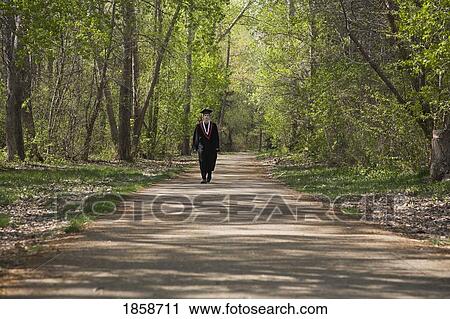 Graduate walking on a road View Large Photo Image Stock Image - Graduate walking on a road. Fotosearch