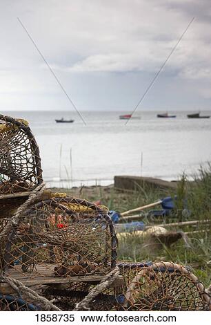 Stock Photography - Lobster traps on shore; Boulmer Beach, Northumberland, England. Fotosearch