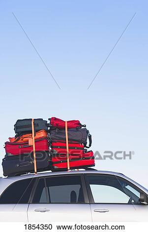 Luggage piled high on a car roof View Large Photo Image Stock Image - Luggage piled high on a car roof. Fotosearch