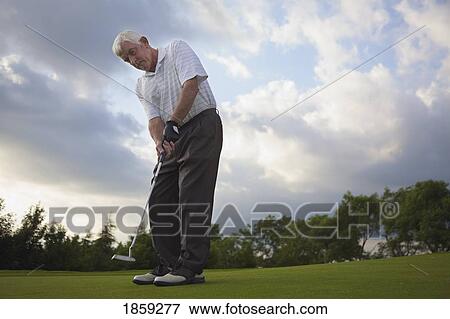 Stock Photo - Man golfing. Fotosearch