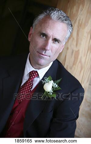 Stock Photography - Man in a suit with flower on his lapel. Fotosearch