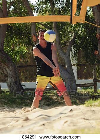 Man playing beach volleyball View Large Photo Image Stock Image - Man playing beach volleyball. Fotosearch