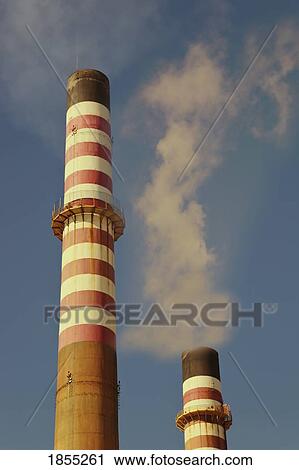 Stock Image - Petrochemical industry smokestacks, La Linea de la Concepcion, Cadiz Province, Spain. Fotosearch