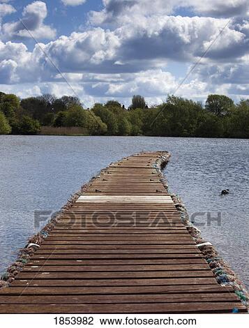 Stock Image - Pier over lake; Hornsea, East Yorkshire, England. Fotosearch