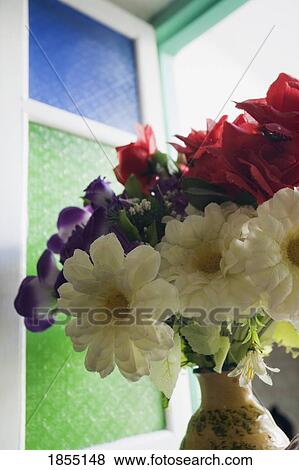Stock Photo - Plastic flowers on window sill. Fotosearch
