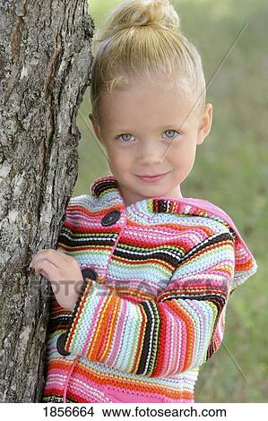 Portrait of girl by a tree View Large Photo Image Picture - Portrait of girl by a tree. Fotosearch