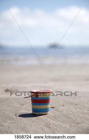 Picture - Sand bucket on beach; Boulmer Beach, Northumberland, England. Fotosearch