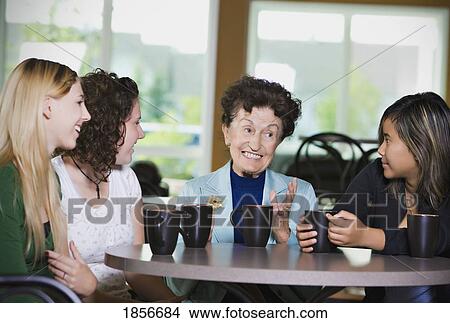 Senior woman chatting over coffee with teenage girls View Large Photo Image Picture - Senior woman chatting over coffee with teenage girls. Fotosearch