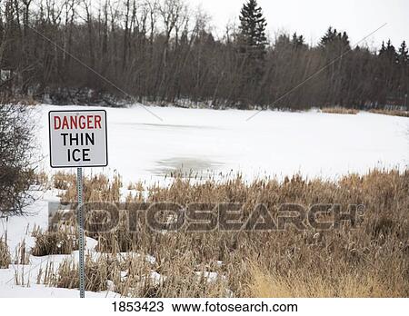 Stock Image - Sign that says "Danger thin ice". Fotosearch