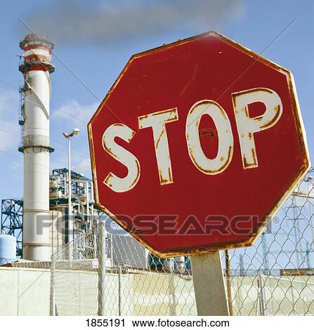Stock Image - Stop sign near industrial buildings, Cadiz Province, Spain. Fotosearch