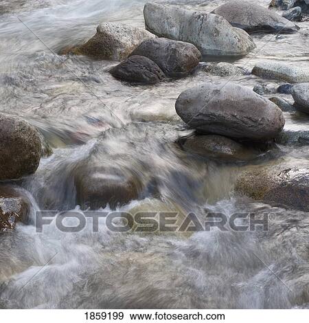 Stock Photo - Water pouring over rocks; Whistler, British Columbia, Canada. Fotosearch