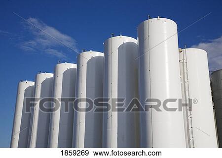 Stock Photo - White industrial chemical storage tanks. Fotosearch