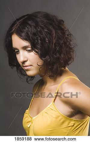 Woman in a yellow tank top View Large Photo Image Stock Photo - Woman in a yellow tank top. Fotosearch