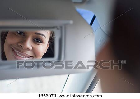 Stock Photo - Woman looking into a mirror. Fotosearch