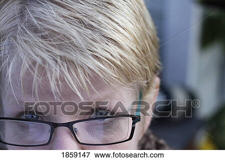 Stock Photo - Woman looking over the rim of her glasses. Fotosearch