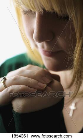 Stock Image - Woman praying. Fotosearch