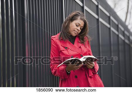 Stock Image - Woman reading a Bible. Fotosearch