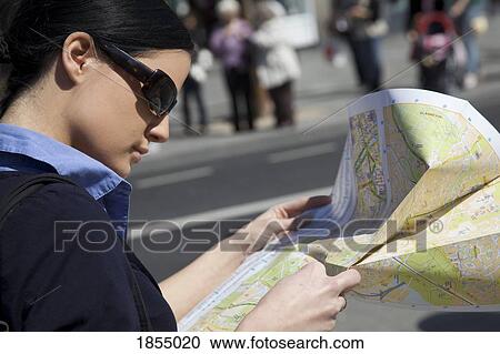 Stock Image - Woman reading a map. Fotosearch