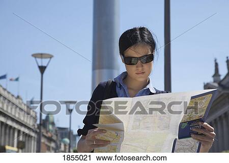 Woman reading a map View Large Photo Image Stock Image - Woman reading a map. Fotosearch