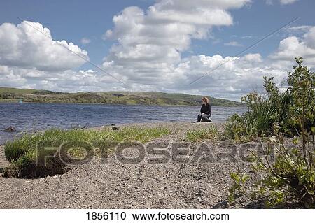Woman sitting on the river's edge, Dumfries and Galloway, Scotland View Large Photo Image Stock Image - Woman sitting on the river's edge, Dumfries and Galloway, Scotland. Fotosearch