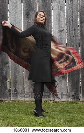 Stock Image - Woman swinging shawl. Fotosearch