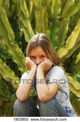 Stock Photography - Young girl with head in hands. Fotosearch