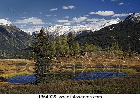 Stock Photography - A pond and mountains with fresh snow. Fotosearch