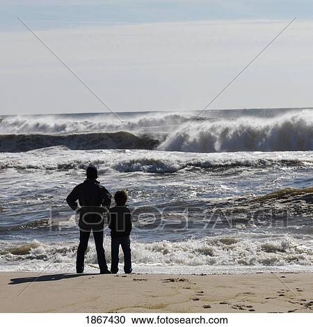 Adult with child on beach, Sag Harbor, New York, USA View Large Photo Image Stock Image - Adult with child on beach, Sag Harbor, New York, USA. Fotosearch
