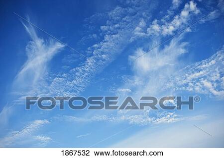 Stock Image - Blue sky with scattered clouds. Fotosearch